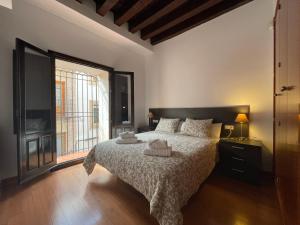 a bedroom with a bed and a large window at Palacio Santa Ursula in Toledo +126 photos
