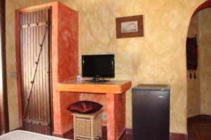 een kamer met een bureau, een televisie en een deur bij Sinai Old Spices B&B in Sharm El Sheikh