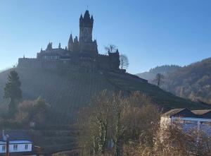 a castle sitting on top of a hill at Haus Mika in Cochem