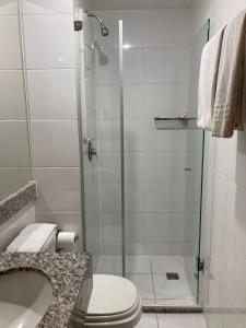 a bathroom with a shower with a toilet and a sink at S4 HOTEL Águas Claras Flat in Brasília