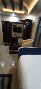 a hotel room with a bed and a tv at Hotel Sara PVT LTD in Janakpur