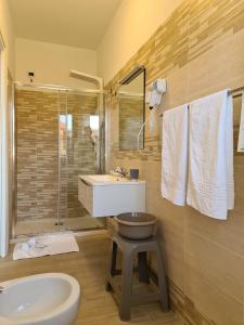 a bathroom with a sink and a toilet and a shower at Hotel La Campagnola in Capo Vaticano