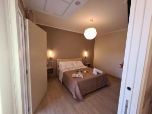 Dormitorio pequeño con cama y lámpara en Hotel La Campagnola, en Capo Vaticano