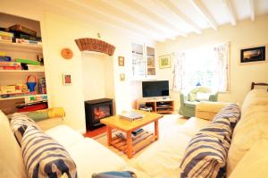 a living room with a couch and a fireplace at Westover, St Mawes in Saint Mawes