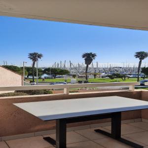 a bench in front of a window with a view of a harbor at STUDIO PORT VAUBAN excellente situation climatisé Box Fibre in Antibes