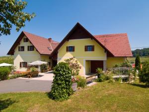 a large yellow house with a red roof at Weingut Schwarzl in Ratsch an der Weinstraße