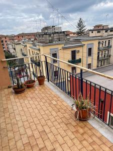 a balcony with potted plants on top of a building at Franchetti House in Catania