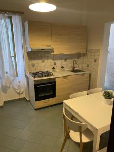 a kitchen with a stove and a table with chairs at Franchetti House in Catania