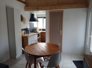 a kitchen with a wooden table and chairs at Gîte La nonnette in Prades
