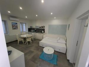 a living room with a couch and a table at MYKONOS APARTMAN in Makó