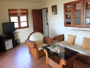 a living room with a couch and chairs and a table at The Waterfront Hotel at Fishermans Village in Bophut 