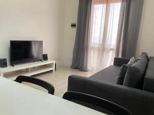 sala de estar con sofá y TV en CapoAlessio, en SantʼAlessio Siculo