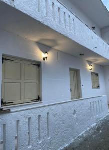 a white building with a mirror on the side of it at Philoxenia traditional house in Palaiólimnos