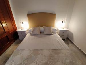 En eller flere senge i et værelse på Apartamento Amplio 6 plazas junto al Centro
