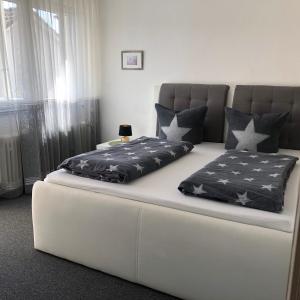 a bed with two pillows on it in a room at Ferienwohnung Rheinfelden (Beuggen) in Beuggen
