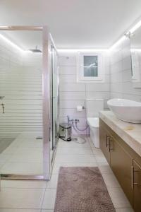 ein Bad mit einer Dusche, einem Waschbecken und einem WC in der Unterkunft The "Maze" by CK&G in Athen