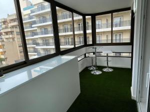 an office with large windows and a green floor at Apartamento IMPERIO 2 - Marbella centro in Marbella