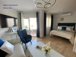 a bedroom with a bed and a living room at Acapulco playa Nerja 407 planta superior in Nerja