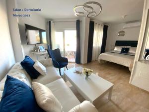 a living room with a white couch and a table at Acapulco playa Nerja 407 planta superior in Nerja