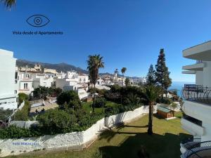 a view of a city with palm trees and buildings at Acapulco playa Nerja 407 planta superior in Nerja
