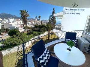 a table and chairs on a balcony with a view at Acapulco playa Nerja 407 planta superior in Nerja