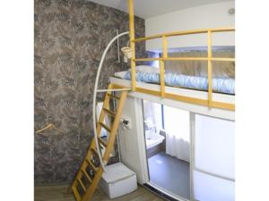 a bunk bed with a ladder in a room at HOTEL StoRK Naha Shintoshin - Vacation STAY 27627v in Naha
