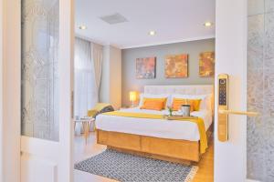 a bedroom with a king sized bed with orange pillows at Casa Asturias in Ensenada