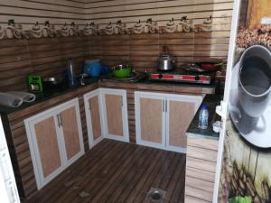 a kitchen with white cabinets and wooden floors at شاليهات رمال بديه in Al Raka +54 photos