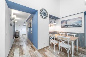 
a kitchen with a table, chairs and a refrigerator at Main Street Apartments by Raspberry Cascade in Faro
