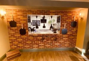 a brick wall with a mirror in a room at Hockley House in Hockley Heath