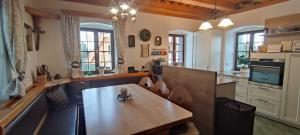 a large kitchen with a wooden table in a room at Die Hube in Leutschach