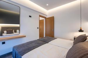 a bedroom with a large bed and a mirror at Cirillo Family Hotel-Christinas Studios in Mastihari