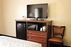 a hotel room with a bed and a television at Bowen Motel in Moab