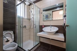 a bathroom with a toilet and a sink and a shower at Cirillo Family Hotel-Christinas Studios in Mastihari