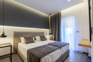 a bedroom with a large bed and a window at Cirillo Family Hotel-Christinas Studios in Mastihari