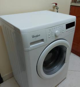 a white washing machine sitting in a room at Nice studio for stay .. in Al Ain