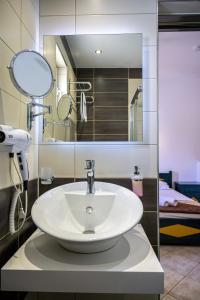 a bathroom with a sink and a mirror at Cirillo Family Hotel-Christinas Studios in Mastihari