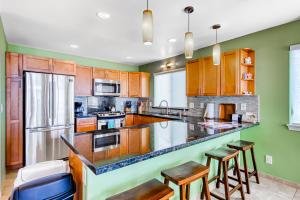 a kitchen with wooden cabinets and a counter top at Hale Aikalani in Pahoa