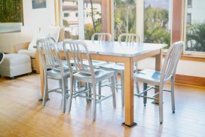 a dining room table with four chairs around it at A Tide that Binds Us in Siesta Key