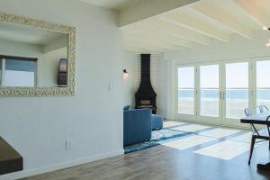 a living room with a fireplace and a mirror at *Location*Beachfront Condo.Endless Views.Surf in Huntington Beach