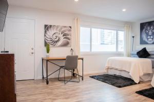 a bedroom with a bed and a desk and a window at *Location*Beachfront Condo.Endless Views.Surf in Huntington Beach