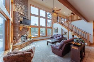 a living room with a couch and a fireplace at Zion Ponderosa Ranch Resort in Springdale