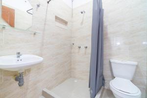 a bathroom with a toilet and a sink at Hotel De Las Mercedes in Palmira +22 photos