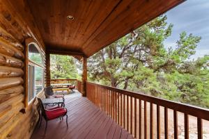 a porch of a log cabin with a bench on it at Zion Ponderosa Ranch Resort in Springdale