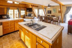 a kitchen with a stove top in a room at Furnished Deck + Fire Pit: Happy Jack Cabin in Happy Jack