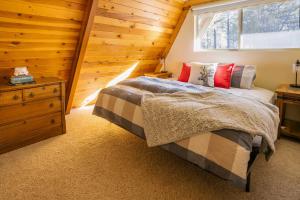 a bedroom with a bed and a window at Furnished Deck + Fire Pit: Happy Jack Cabin in Happy Jack