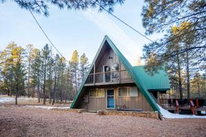 a house with a green roof at Furnished Deck + Fire Pit: Happy Jack Cabin in Happy Jack