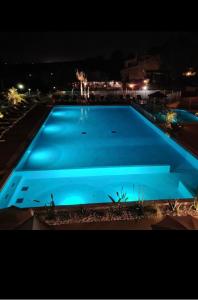 - une grande piscine bleue la nuit dans l'établissement Mobil home 8 personnes camping l ile d or saint raphael, à Saint-Raphaël