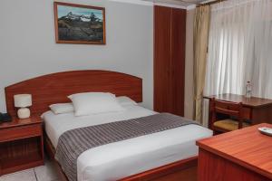 Postel nebo postele na pokoji v ubytování Grand Hotel Machala