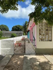 a fence in front of a small house at Onda Colorida - Praia de Serrambi CASA 2 - VERDE in Porto De Galinhas